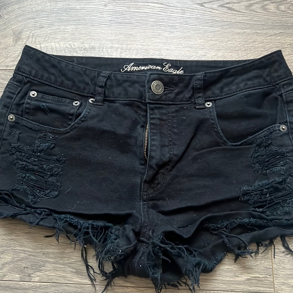 American eagle black shorts with rips.